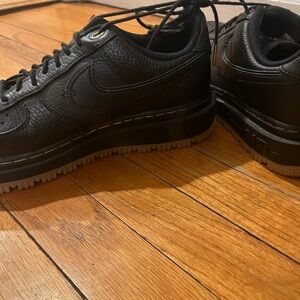 Nike Black Sneakers with Textured Upper and Thick Rubber Sole